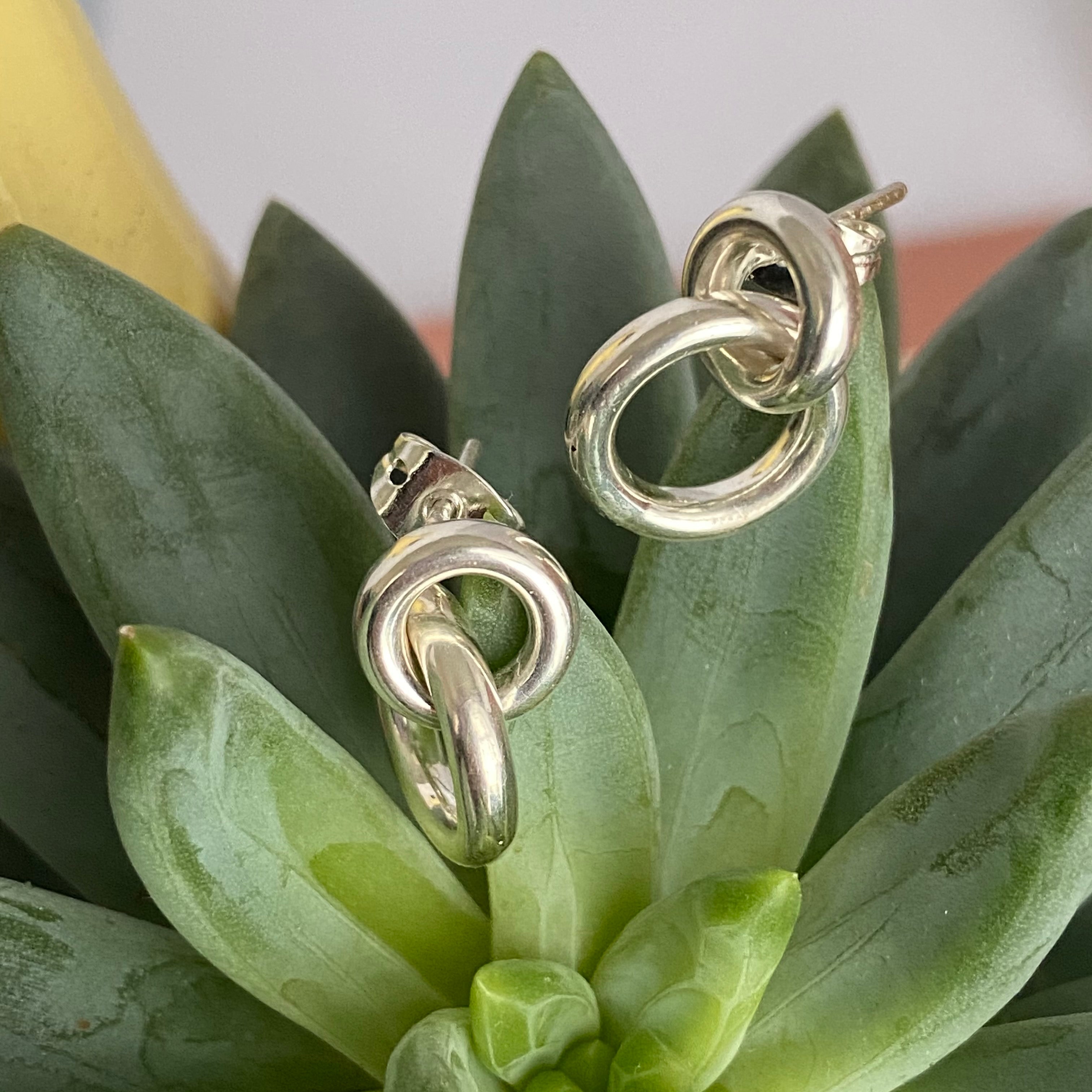 Two Small Interlinked Hoop Sterling Silver Stud Earrings